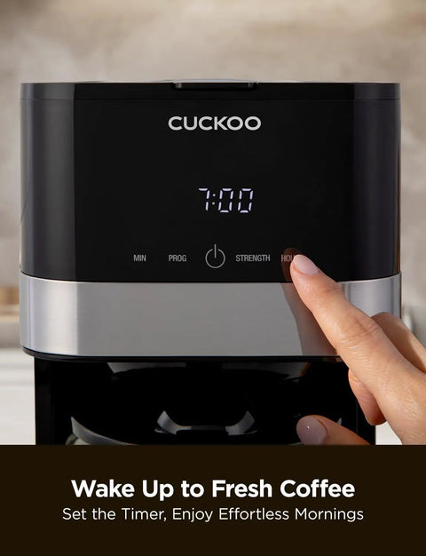 10 Cup Drip Coffee Maker With 24 Hour Programmable Timer displayed with digital clock and user pressing a button