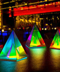 Pyramid Modern Table Lamp Led Desk Light with colorful transparent glow, 3D acrylic home decor in a vibrant nightlife setting.