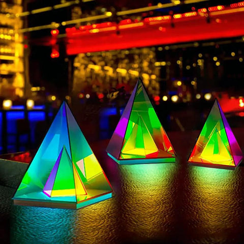 Pyramid Modern Table Lamp Led Desk Light with colorful transparent glow, 3D acrylic home decor in a vibrant nightlife setting.
