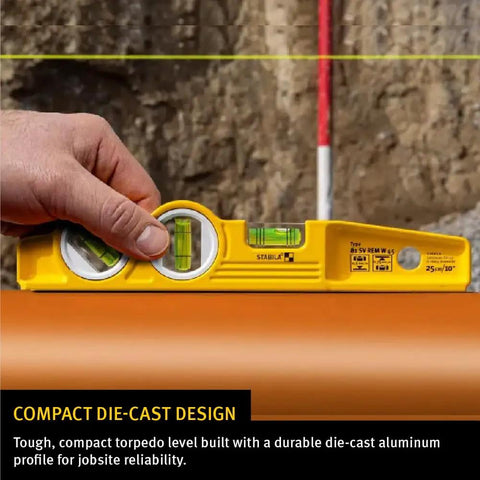 Hand holding Die Cast Torpedo Level With Protractor Vial And Adjustable 360 Degree Vial, checking surface levelness.