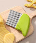 2-piece crinkle cutter set with green handles and stainless steel wavy blades on a wooden cutting board