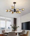 Interior view with 8-Light Black And Gold Sputnik Light Fixture Modern Chandelier With Smoked Glass Globes in dining room.