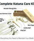 All In One Blade Cleaning And Maintenance Kit For Japanese Sword Care items including choji oil, uchiko ball, rice paper, brass hammer.