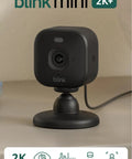 Hella Crisp Two Pack Indoor Security Cameras Running Smooth With 2K Video Resolution Compact Plug In Build Night Vision And Knockout Motion Detection Reliable Home And Pet Monitoring Black on a table setup