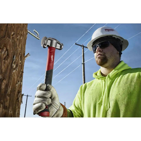 Absolute Beast Heavy Duty 4In1 Lineman Hammer 36 Oz Strike Built Different For Electricians And Job Site Pros Tough As Nails With Grippy Handle in use outdoors.