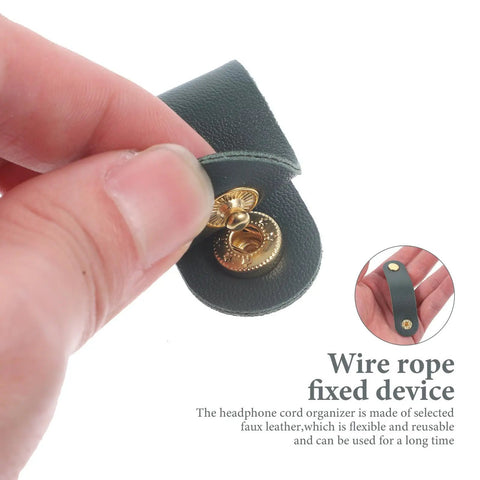 Close-up of a hand holding a Five Piece Artificial Leather Cord Keeper with gold snap, designed for organizing cables.