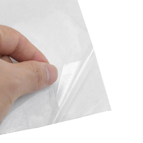 Hand peeling back the corner of Killer Slick Clear Self Adhesive Wall Paper Roll for easy installation in kitchens.