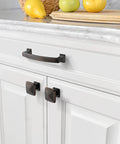 Oil Rubbed Bronze Cabinet Pulls, 4 Inch Center-To-Center, mounted on white kitchen cabinets with marble countertop.
