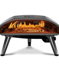 Front view of Koda 16 Natural Gas Pizza Oven for Outdoor Cooking with flames inside, foundry black steel, pizza on stone.