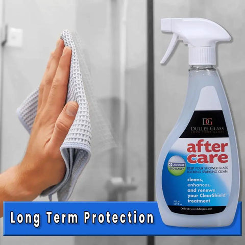 Hand cleaning shower glass with Aftercare Shower Door Cleaner For Glass And Ceramic Non Abrasive Glass Cleaner That Protects And Conditions Bathroom Surfaces Extends Shower Glass Durability From 5 To 8 Years With One Monthly Spray For A Slick Streak Free Shine and a cloth next to the product bottle.