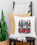 Chair with a pillow featuring 'Being a Mom Makes My Life Complete' in floral and leopard print. Four Pack Iron On Transfers For T Shirts DTF Ready To Press Easy To Apply With Any Home Iron Or Heat Press Floral Mama Leopard Print Designs For Clothes Pillows Bags And DIY Crafts Assorted Sizes.