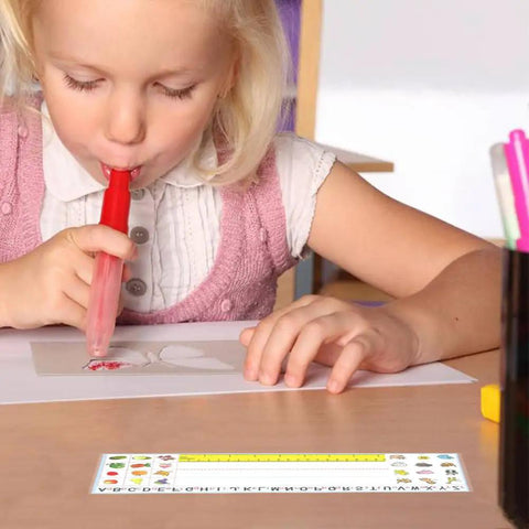 Child using colored marker at desk with clear adhesive pocket holding alphabet nameplate