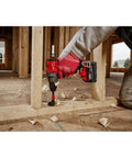 Game Changing Brushless Cordless Drill Driver Combo Set With Dual 5Ah Batteries Multi Voltage Charger And Snug Construction in use on a wooden frame.