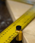 Beefy Brass Stair Gauge Set For Framing And Carpentry Squares showing brass body with large knobs on yellow ruler for precise cuts
