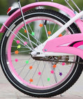 Colorful Star Shaped Spoke Beads For Kids Bikes Clip On Plastic Spoke Beads Set on a pink bicycle wheel, showing vibrant star decorations
