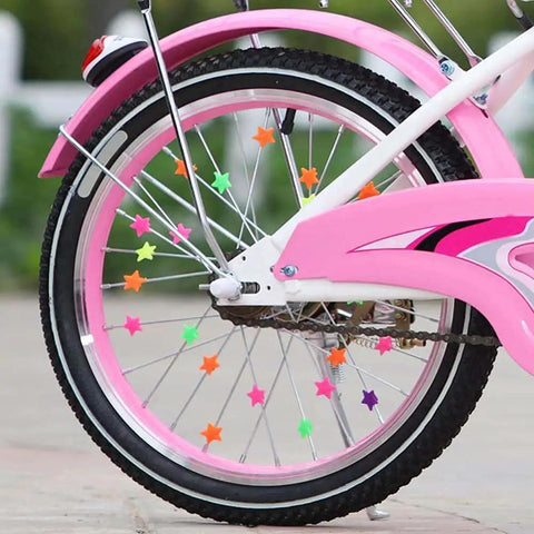 Colorful Star Shaped Spoke Beads For Kids Bikes Clip On Plastic Spoke Beads Set on a pink bicycle wheel, showing vibrant star decorations