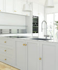 Six Pack Gold Dresser Knobs For Drawers And Cabinets Hardware Pulls In Brushed Brass Vintage Luxury Finish installed on white kitchen cabinets.