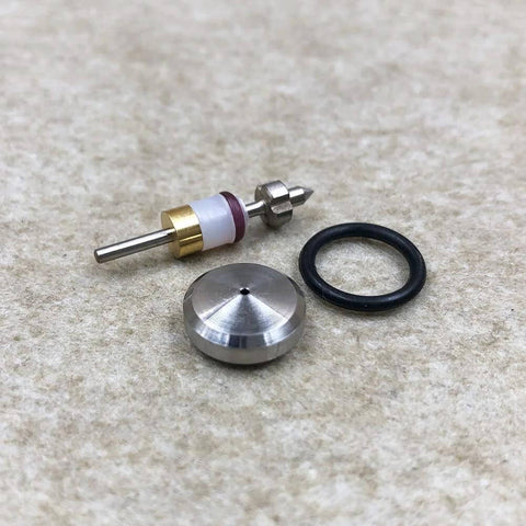 Close-up of water jet on/off valve repair kit parts: valve stem, brass collar, conical tip, aluminum plug, O-ring.