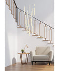 Knockout Modern 16 Light Square Ceiling Pendant Fixture Featuring Smooth Chrome Finish Genuine Crystal Drops Straight Up Durable Build Quality Ideal For Luxe Interior Vibes hanging over a modern seating area by stairs.