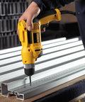 Person using Corded Drill Beast With 8 Amp Motor, 0-2,500 RPM, 3/8 Inch Keyless Chuck on metal beam