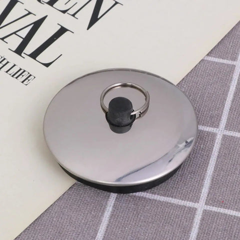 2pcs Rubber Bathtub Drain Stopper for Kitchen and Laundry Use, round rubber seal with metal ring on gray fabric.