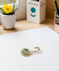 Pack Of 4 Self Adhesive Wall Hooks Featuring A Vintage Diamond Design on a desk with stationery, flower pot.