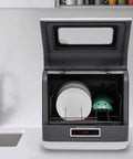 Premium Portable Countertop Dishwasher Built From Heavy Duty Stainless Steel Featuring Three Rapid Wash Settings, open showing plates.