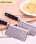 Two crinkle cutter knives with black ergonomic handles and stainless steel wavy blades; front view on a wooden surface.