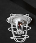 Set Of Four Stainless Steel Fire Sprinkler Cage Guards For Half Inch Heads Heavy Duty Anti Collision Shields Rock Solid Construction No Mess Setup Keeps Your Building Code Essentials Running Tight - close-up view of a sprinkler head guard.