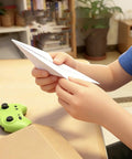 Child assembling RC Paper Airplane Kit With Gyro Stabilizer For Beginners And Hobbyists DIY Electric Remote Control Plane