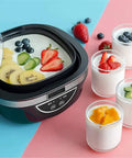 No Sweat Automatic Yogurt Maker With Four Leakproof Glass Jars filled with yogurt topped with fresh fruits on a pastel background.