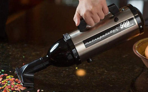 Person using VM6SB500 500W 120V High Performance Hand Vacuum With All Steel Build And Beastly Suction on countertop