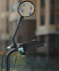 Upgrade Your Ride With This Smart LED Display Throttle Grip Pair Designed For 24-60V Ebike Systems Featuring Secure Lock-On Aluminum Clamps And Real-Time Battery Voltage Monitoring For A Safer And Smoother Electric Bike Journey No More Guessing What. black e-bike throttle grip with LED voltage display on handlebar