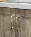 Six Pack 5 Inch Center To Center Modern Champagne Bronze Cabinet Pulls with sleek tapered handles on wooden kitchen cabinets