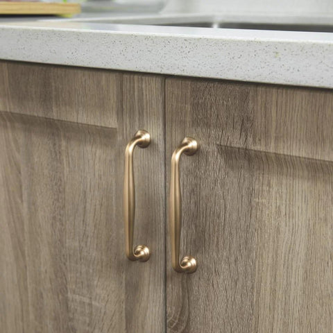 Six Pack 5 Inch Center To Center Modern Champagne Bronze Cabinet Pulls with sleek tapered handles on wooden kitchen cabinets