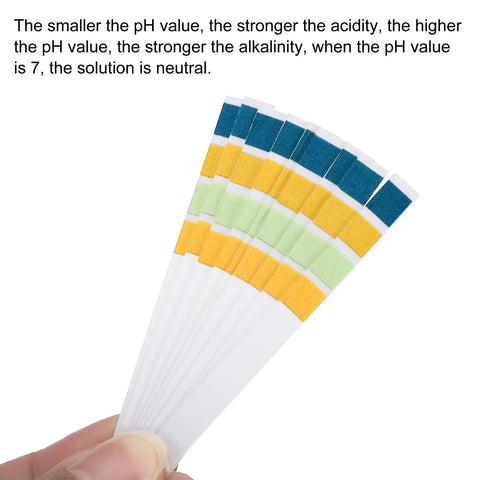 Hand holding pH Test Strips 0 To 14, 100 Indicator Papers Litmus Tester for acidity and alkalinity testing