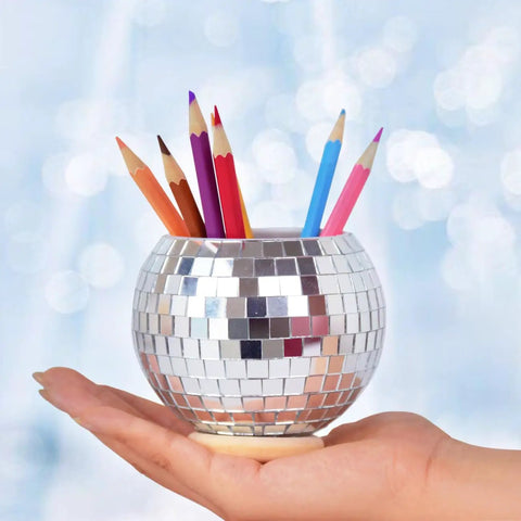 Hand holding Disco Pen Holder Sequin Desk Organizer With Base That Doubles As Makeup Brush Holder And Pencil Cup For Home Office Classroom Silver Dope Reflective Finish For A Modern Look And Easy Access On Your Desk with pencils inside, showcasing its multipurpose use.