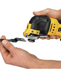 Hands holding an Oscillating Tool With 3 Amp Corded Motor, Quick Change Attachments visible, demonstrating blade attachment.