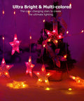 Star Curtain Lights 10ft By 3.3ft RGB LED Color Changing String Fairy Lights With 130 LEDs And 10 Stars, Smart App And IR Remote, 200 Plus Scene Modes For Bedroom Backdrop, Indoor Outdoor Christmas Decor And Party Vibe, showing glowing multi-colored stars on a dark background.