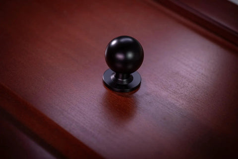 Matte Black Cabinet Knob with Large Ball Design on Wood Surface for Kitchen Cabinets and Dressers