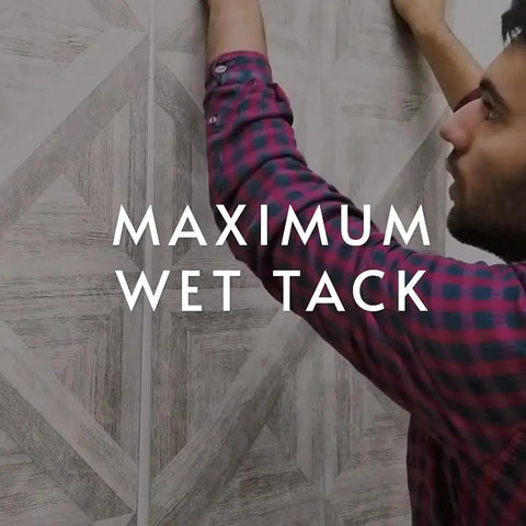 Person applying wallpaper using Ultra Clear Strippable Wallpaper Adhesive for most wallpaper types, Pro 880 Formula, 32 oz.