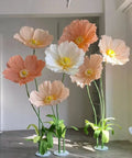 Tall artificial flowers with 32ft Long 20mm PVC Flexible Pipe Tubing For Floral Arches And DIY Decor used as stems, in a bright indoor setting.