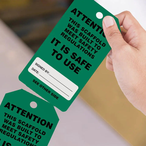 OSHA Compliant Scaffolding Tags By The Roll, Attention Sign To Keep Scaffolds Safe And On Point, held in hand