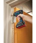 Compact 18V One Quarter Inch Hex Impact Driver Bare Tool with LED used for door hinge installation in tight space.