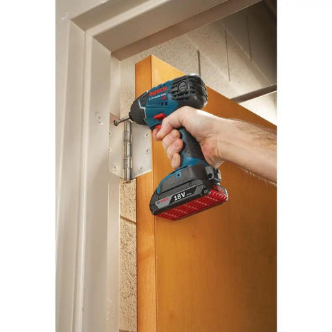 Compact 18V One Quarter Inch Hex Impact Driver Bare Tool with LED used for door hinge installation in tight space.