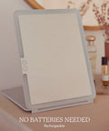 Your Go To LED Travel Vanity Mirror With 3 Color Ring Light on a table, highlighting rechargeable feature.