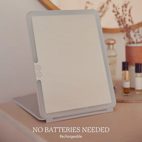 Your Go To LED Travel Vanity Mirror With 3 Color Ring Light on a table, highlighting rechargeable feature.