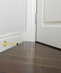 Gold wall-mounted hydraulic door stopper for bathroom and apartment doors, adjustable 28mm aluminum alloy build, noise reduction.