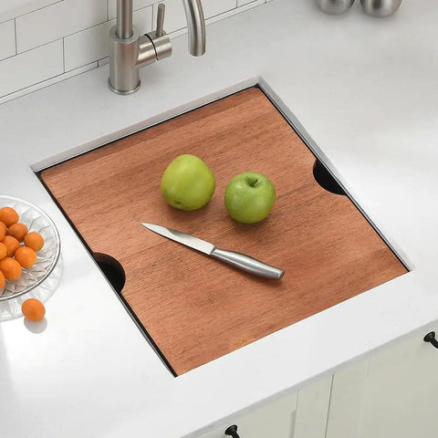 Wooden cutting board over undermount bar sink 13x15 inches 16 gauge stainless steel deep basin nine inch depth with three and a half inch drain.