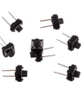 Top view of 6x6x6 mm Tactile Push Button Switches, 2-pin momentary, pack of 20, for DIY electronics, 50mA 12VDC, scattered layout.